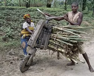 Related Images Gallery: A young man and his wife push a homemade wooden bicycle