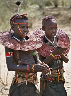 Two young Pokot girls wearing traditional ornaments that denote their unmarried status Two young Pokot girls wearing traditional ornaments that denote their unmarried status