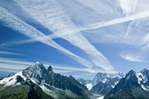 Airplane vapour trails over the Mer du glace Chamonix France Cause and affect As planes continue to pump out huge