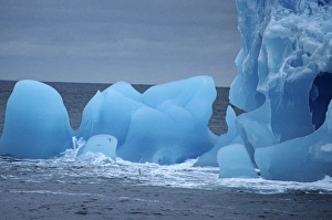 Close detail of blue iceberg full of holes and cavities. Near Antarctic Peninsula, Antarctica Close detail of blue iceberg full of holes and cavities. Near Antarctic Peninsula, Antarctica