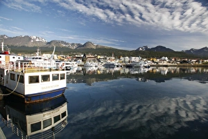 The harbor at Ushuaia, Argentina on a very rare calm and sunny day. Ushuaia claims to be the southernmost city in The harbor at Ushuaia, Argentina on a very rare calm and sunny day. Ushuaia claims to be the southernmost city in