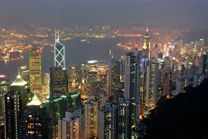 Hong Kongs modern skyline overlooking Victoria harbour and Kowloon peninsula at night, Hong Kong
