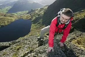 A man scrambling on Pavey Ark in the Lake District UK