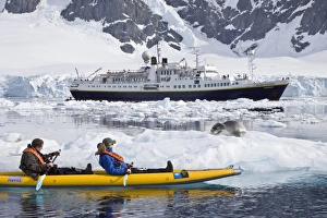 National Geographic photographer Joel Sartore and his wife Kathy kayaking with a leopard National Geographic photographer Joel Sartore and his wife Kathy kayaking with a leopard