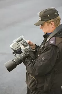 Images Dated 15th August 2007: A police photographer photographing protestors at the Climate camp protest against airport