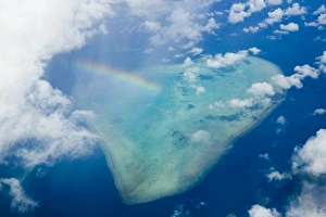 A rainbow over tropical reef near Tuvalu in the Pacific ocean A rainbow over tropical reef near Tuvalu in the Pacific ocean