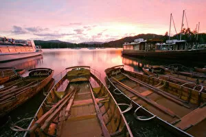 Plank Gallery: Rowing boats at Waterhead Ambleside on Lake Windermere at sunset in the Lake District UK