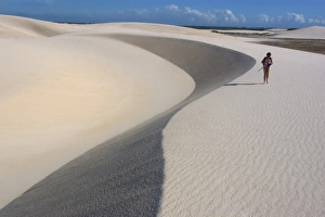 Tourist walks on the sand dunes of Lencois Maranhenses National Park, Santo Amaro, Maranh'o, Brazil Tourist walks on the sand dunes of Lencois Maranhenses National Park, Santo Amaro, Maranh'o, Brazil