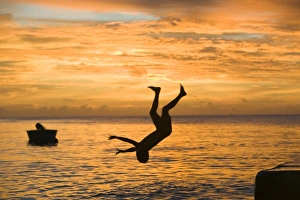 Tuvaluan children leaping into the sea on Funafuti atol Tuvalu Tuvaluan children leaping into the sea on Funafuti atol Tuvalu