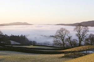 Valley mist over Windermere at dawn in the Lake District UK Valley mist over Windermere at dawn in the Lake District UK