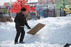Ethnic Gallery: Workers in Heihe on the Chinese Russian border shovel heavy snow from the worst snowstorm to hit
