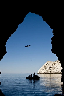 Zodiac approaching a cave at Isla San Pedro Martir in the midriff region of the Gulf of California (Sea of Cortez) Zodiac approaching a cave at Isla San Pedro Martir in the midriff region of the Gulf of California (Sea of Cortez)