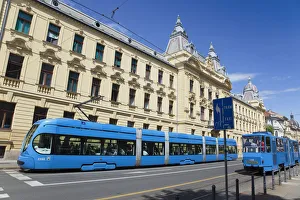 Croatia, Zagreb, Old town, Mihanoviceva Street, Hz Vuca Vlakova national railway headquarters with tram apssing by Croatia, Zagreb, Old town, Mihanoviceva Street, Hz Vuca Vlakova national railway headquarters with tram apssing by
