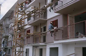 CUBA Construction workers and painters on wooden scaffolding working on muli-storey CUBA Construction workers and painters on wooden scaffolding working on muli-storey