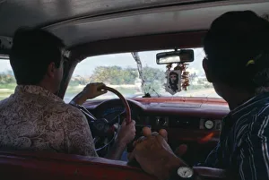 Cuba, Interior of car with image of Che Guevara hanging beneath rear view mirror Cuba, Interior of car with image of Che Guevara hanging beneath rear view mirror