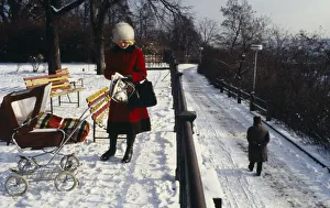 CZECH REPUBLIC, Prague Woman stopped to read newspaper in park in the snow CZECH REPUBLIC, Prague Woman stopped to read newspaper in park in the snow