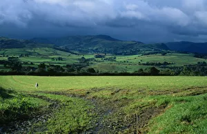 England, Cumbria, Lake District, View across green field from Blencathra centre towards Saddle Beck and Lowrigg England, Cumbria, Lake District, View across green field from Blencathra centre towards Saddle Beck and Lowrigg