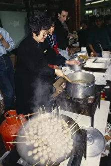 Images Dated 6th July 2009: ENGLAND, London, Chinese New Year Women cooking on street stall during New Year