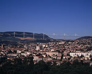 FRANCE, Midi-Pyrenees, Aveyron Millau. Cityscape with Millau bridge beyond which FRANCE, Midi-Pyrenees, Aveyron Millau. Cityscape with Millau bridge beyond which