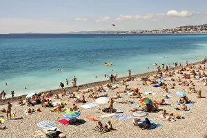 France, Nice, Baie Des Anges and tourists sunbathing on beach