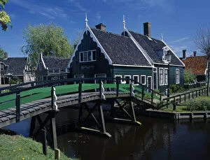 HOLLAND, Noord Holland, Zaanse Schans Footbridge leading to a typical green wooden