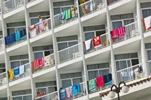 Hotel balconies with beach towels drying over balustrades Hotel balconies with beach towels drying over balustrades