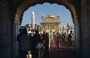 Images Dated 23rd June 2008: INDIA, Punjab, Amritsar Entrance arch to the Golden Temple with people walking along