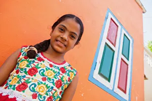 India, Tamil Nadu, Mahabalipuram, Portrait of a Tamil girl standing outside her orange painted home in Mahabalipuram India, Tamil Nadu, Mahabalipuram, Portrait of a Tamil girl standing outside her orange painted home in Mahabalipuram