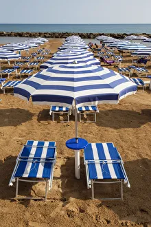 Italy, Sicily, Marina Di Ragusa, Sun umbrellas and sun beds on a beach Italy, Sicily, Marina Di Ragusa, Sun umbrellas and sun beds on a beach