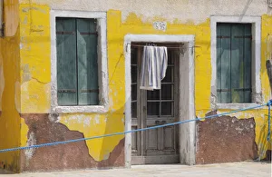 Italy, Veneto, Venice, Burano, faded yellow house Italy, Veneto, Venice, Burano, faded yellow house