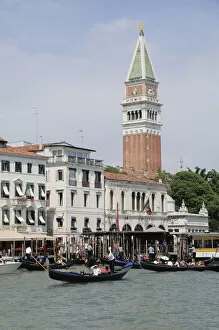Italy, Veneto, Venice, gondolas leaving from Piazza San Marco with campanile indistance