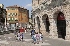 Italy, Veneto, Verona, Arena exterior on Piazza Bra with people walking past