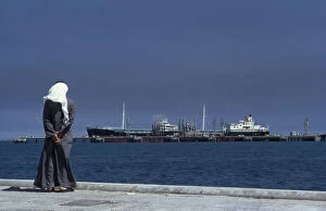 Images Dated 22nd September 2009: KUWAIT, Mina Ahmadi Man wearing a white headscarf looking out across the sea towards