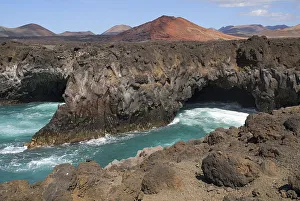 Los Hervideros or Boiling Waters from viewpoint on south west coast road. The sea crashes through lava formed tunnels Los Hervideros or Boiling Waters from viewpoint on south west coast road. The sea crashes through lava formed tunnels