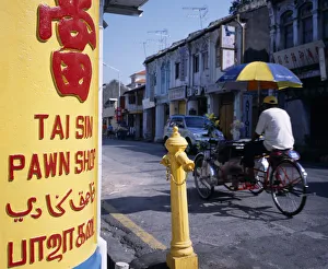 MALAYSIA, Penang, Georgetown Lebuh Chulia. Cycle rickshaw on street with yellow MALAYSIA, Penang, Georgetown Lebuh Chulia. Cycle rickshaw on street with yellow