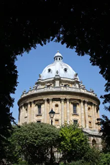 The Radcliffe Camera library building seen through arch of foliage The Radcliffe Camera library building seen through arch of foliage