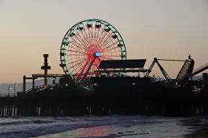 Santa Monica pier Silhouetted at dusk. Ferris wheel funfair Santa Monica pier Silhouetted at dusk. Ferris wheel funfair