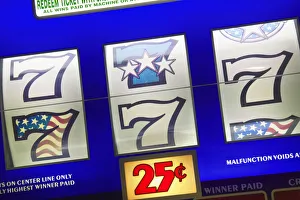 Detail of slot machine dials showing the lucky number seven and 25 cents to play Detail of slot machine dials showing the lucky number seven and 25 cents to play