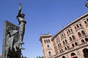 Images Dated 20th August 2014: Spain, Madrid, Statue of a matador with the Plaza de Toros de las Ventas in the