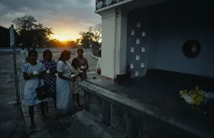 Sri Lanka, Anuradhapura, Wesak Festival, Women with flower offerings at sunset Sri Lanka, Anuradhapura, Wesak Festival, Women with flower offerings at sunset