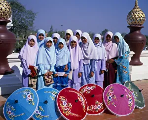 THAILAND, North, Chiang Mai Group of young Muslim Thai women standing behind blue, red THAILAND, North, Chiang Mai Group of young Muslim Thai women standing behind blue, red