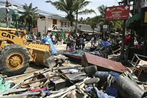 Tsunmai carnage the day after. The clean up starts from What is left of some shops and bars at Patong on the beach road