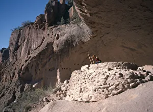 Images Dated 6th October 2008: USA New Mexico Bandelier National Monument Visitor climbing ladder amongst caves