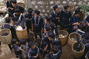 VIETNAM North Sapa Muong tribes people carrying woven panniers at market VIETNAM North Sapa Muong tribes people carrying woven panniers at market