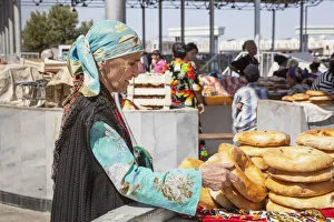Woman buying non bread, Siyob Market, also known as Siab Market, Samarkand, Uzbekistan Woman buying non bread, Siyob Market, also known as Siab Market, Samarkand, Uzbekistan