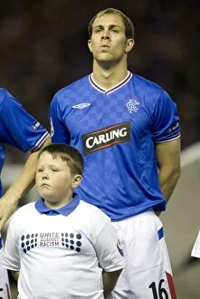 Rangers FC vs Unirea Urziceni: Ibrox Showdown - Champions League Qualifying Group Stage, Group G: Rangers' Steven Whittaker and the Mascot Amidst a 1-4 Defeat