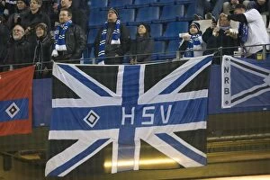 Football Action Friendly Collection: Tense Soccer Rivalry: Hamburg's 2-1 Victory over Rangers at Imtech Arena - A Triumph for the Home