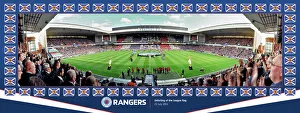 <b class=qtipBold><figcaption>Unfurling of the League Flag</figcaption></b><br>Special edition framed panoramic in silver frame to celebrate 54 league titles. RANG448 762x288mm (30x11.5 inchesÂ)<br><em>© Arena Imaging</em> Unfurling of the League Flag