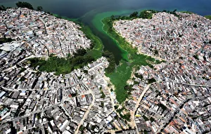 An aerial view shows illegally built slums on the border of the polluted water of An aerial view shows illegally built slums on the border of the polluted water of