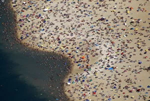 Related Images Gallery: An aerial view shows people at a beach on the shores of the Silbersee lake on a hot